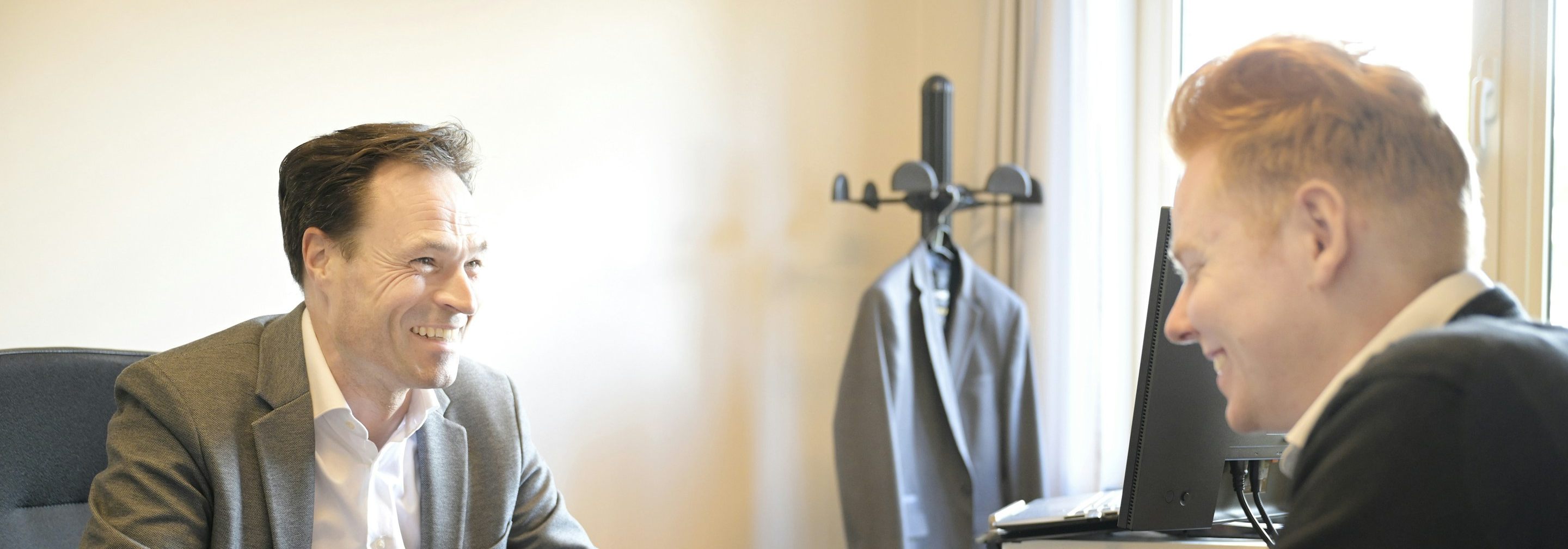 A CPA and a client going over documents together at an office desk
